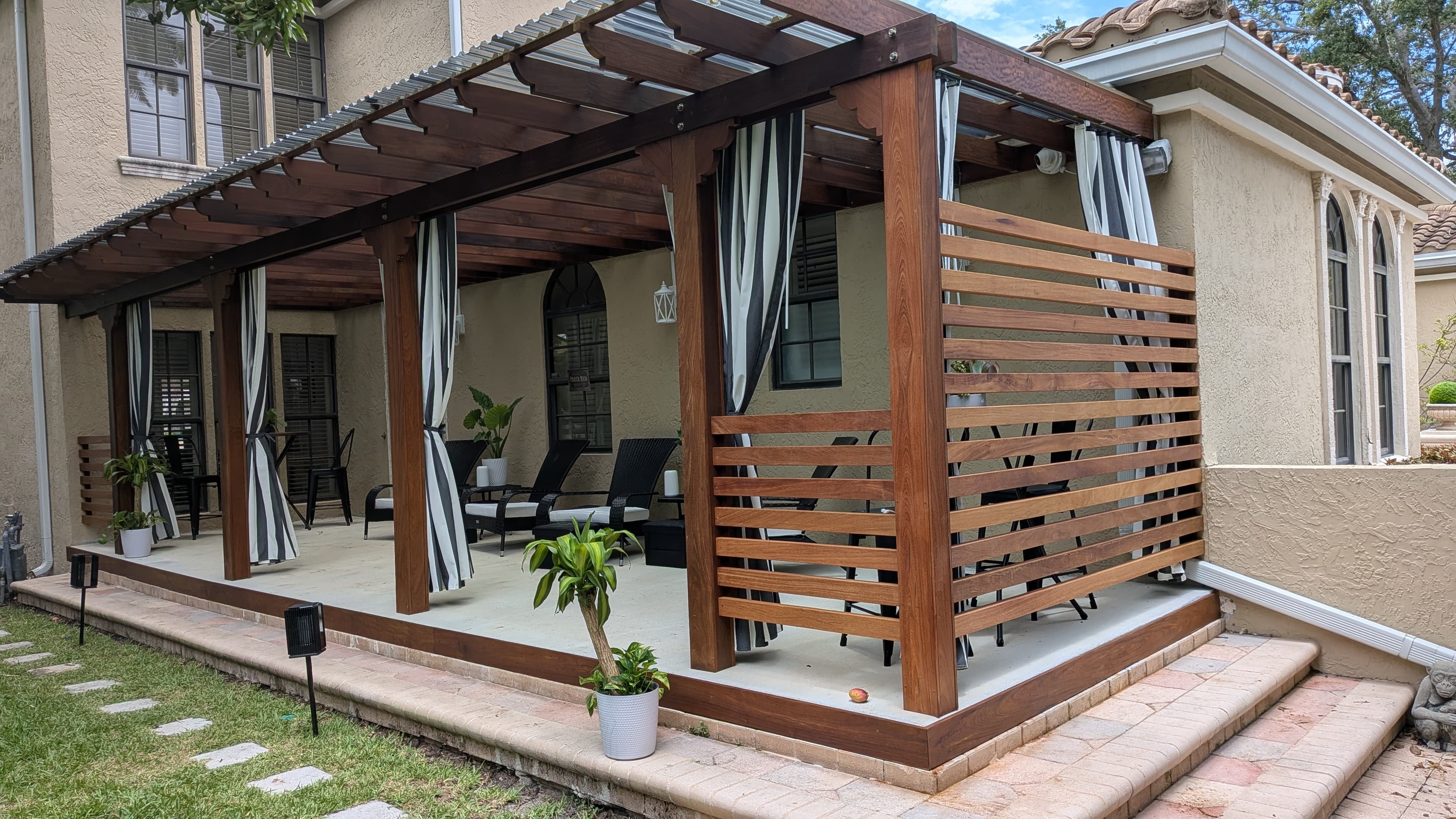 Professional hardwood deck restoration specialist applying oil finish